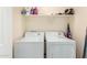 Functional laundry room with washer, dryer, and storage at 7844 W Bonitos Dr, Phoenix, AZ 85035