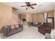 Living room with tiled floors, seating, and staircase at 7844 W Bonitos Dr, Phoenix, AZ 85035