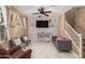 Spacious living room featuring a stone accent wall and plush seating at 7844 W Bonitos Dr, Phoenix, AZ 85035