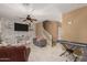 Bright living room with stone wall, hardwood floors, and comfortable seating at 7844 W Bonitos Dr, Phoenix, AZ 85035