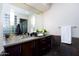 Modern bathroom with dark wood vanity and a large mirror at 7878 E Gainey Ranch Rd # 3, Scottsdale, AZ 85258