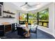 Bright breakfast nook with glass table and black chairs, overlooking a garden at 7878 E Gainey Ranch Rd # 3, Scottsdale, AZ 85258