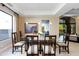 Elegant dining room featuring a glass table and dark wood chairs at 7878 E Gainey Ranch Rd # 3, Scottsdale, AZ 85258