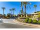 Gated community entrance with palm trees and landscaping at 7878 E Gainey Ranch Rd # 3, Scottsdale, AZ 85258