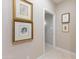 A hallway with framed artwork and access to other rooms at 7878 E Gainey Ranch Rd # 3, Scottsdale, AZ 85258