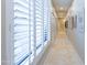 Bright hallway with plantation shutters and art at 7878 E Gainey Ranch Rd # 3, Scottsdale, AZ 85258