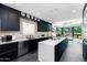 Modern kitchen with dark cabinetry and large island at 7878 E Gainey Ranch Rd # 3, Scottsdale, AZ 85258