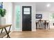 Bright entryway with dark gray door and wood-look flooring at 8025 E Redwing Rd, Scottsdale, AZ 85250