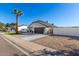 Home exterior view from the street, showing driveway and yard at 8025 E Redwing Rd, Scottsdale, AZ 85250