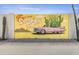 A vibrant exterior wall mural depicting a classic car and desert landscape at 8025 E Redwing Rd, Scottsdale, AZ 85250