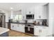 Modern kitchen with white cabinets, stainless steel appliances, and a dark countertop at 8025 E Redwing Rd, Scottsdale, AZ 85250