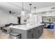 Open concept kitchen with large island, dark grey cabinets, and white countertops at 8025 E Redwing Rd, Scottsdale, AZ 85250