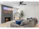 Living room with sectional sofa, fireplace, and ceiling fan at 8025 E Redwing Rd, Scottsdale, AZ 85250