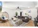 Living room with sectional sofa, fireplace, and a statement chair at 8025 E Redwing Rd, Scottsdale, AZ 85250