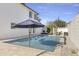 Inviting backyard pool with patio furniture and umbrella at 8025 E Redwing Rd, Scottsdale, AZ 85250