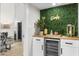 Stylish wet bar with wine cooler and green wall at 8025 E Redwing Rd, Scottsdale, AZ 85250