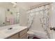 Clean bathroom with shower/tub combo and floral curtains at 8631 W Monte Vista Rd, Phoenix, AZ 85037