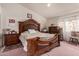 Bedroom with wood furniture, including a large bed and dresser at 8631 W Monte Vista Rd, Phoenix, AZ 85037