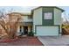 Two-story house with a green facade, attached garage, and a landscaped front yard at 8631 W Monte Vista Rd, Phoenix, AZ 85037