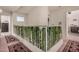 Upstairs hallway with decorative railing and carpet at 8631 W Monte Vista Rd, Phoenix, AZ 85037