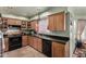 View of kitchen with wood cabinets, granite countertops, and a built-in dishwasher at 8631 W Monte Vista Rd, Phoenix, AZ 85037