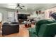 Living room with leather armchairs, coffee table, and a large TV at 8631 W Monte Vista Rd, Phoenix, AZ 85037