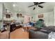 Living room with leather sofas and chairs, a large TV, and wood flooring at 8631 W Monte Vista Rd, Phoenix, AZ 85037