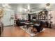 Living room with leather sofas, a coffee table, and wood flooring at 8631 W Monte Vista Rd, Phoenix, AZ 85037