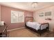 Charming bedroom with a full-size bed and built-in shelving at 8707 N 3Rd Ave, Phoenix, AZ 85021