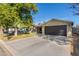 Tan house with dark garage door and driveway at 8707 N 3Rd Ave, Phoenix, AZ 85021