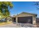 Tan house with dark garage door and driveway at 8707 N 3Rd Ave, Phoenix, AZ 85021