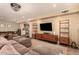 Spacious living room featuring a sectional sofa and mid-century modern media console at 8707 N 3Rd Ave, Phoenix, AZ 85021