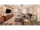 Modern living room with sectional sofa, flat-screen TV, and stylish shelving at 8707 N 3Rd Ave, Phoenix, AZ 85021