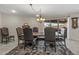 Elegant dining room featuring a rustic wood table and leather chairs at 9714 W Rodeo Ct, Sun City, AZ 85373