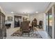 Formal dining room featuring a large table, antique china cabinet, and access to patio at 9714 W Rodeo Ct, Sun City, AZ 85373