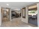 Elegant entryway with tile flooring and view into formal dining room at 9714 W Rodeo Ct, Sun City, AZ 85373