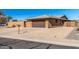 Tan brick home with a brown garage door and a mailbox at 9714 W Rodeo Ct, Sun City, AZ 85373