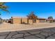 Tan brick single-story home with a brown garage door and desert landscaping at 9714 W Rodeo Ct, Sun City, AZ 85373