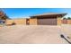 Front view of the house and driveway; tan brick exterior at 9714 W Rodeo Ct, Sun City, AZ 85373