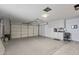 Spacious garage with ample storage cabinets and workspace at 9714 W Rodeo Ct, Sun City, AZ 85373