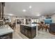 Open concept kitchen with island, stainless steel appliances, and dark wood cabinets at 9714 W Rodeo Ct, Sun City, AZ 85373