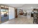 Living room with patio access and view to kitchen at 9714 W Rodeo Ct, Sun City, AZ 85373