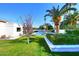 Landscaped backyard with a swimming pool and a whitewashed wall at 9789 E Cinnabar Ave, Scottsdale, AZ 85258