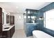 Modern bathroom with blue tile and a soaking tub at 9789 E Cinnabar Ave, Scottsdale, AZ 85258