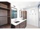 Bathroom with dark wood cabinets and double sinks at 9789 E Cinnabar Ave, Scottsdale, AZ 85258