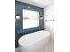 Modern bathroom with soaking tub and blue tile at 9789 E Cinnabar Ave, Scottsdale, AZ 85258