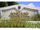 Elegant community entrance sign with colorful flowers at 9789 E Cinnabar Ave, Scottsdale, AZ 85258