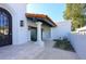 Inviting front patio with a decorative door, columns, and tile flooring at 9789 E Cinnabar Ave, Scottsdale, AZ 85258