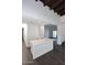 White kitchen island with a quartz countertop and dark wood cabinets at 9789 E Cinnabar Ave, Scottsdale, AZ 85258