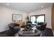 Cozy sitting area with gray armchairs, coffee table, and sliding glass doors at 9789 E Cinnabar Ave, Scottsdale, AZ 85258